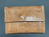 wallet case made of brown leather with a snake skin pattern