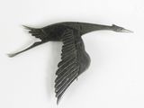 a metal bird that is flying in the air