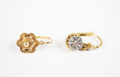 a pair of gold and diamond earrings on a white background