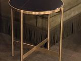 a black table with a gold base in a living room