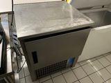 a silver refrigerator sitting in a kitchen next to a stove