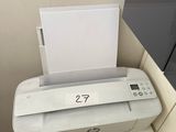 a printer sitting on top of a shelf next to a fire hydrant