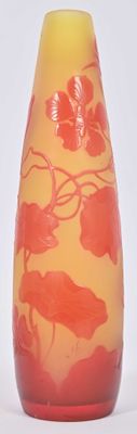 a yellow and red vase sitting on a white surface