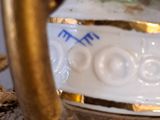 a close up of a vase with a bird on it