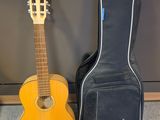 guitar case and acoustic guitar sit next to each other on the floor