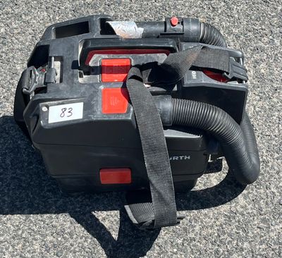 an image of a corded blower sitting on the ground