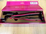 packaging of a hair straightener in a pink box on a wooden table