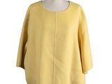the back view of a yellow sweater with a white collar