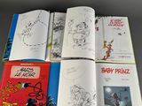 several children ' s books are lined up on a table