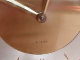 a clock that is sitting on a table in a room