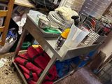 a kitchen cart with dishes and utensils on top of it