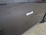 a car with a sticker on the side of it ' s door