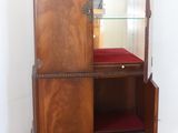 a wooden cabinet with a mirror on top of it