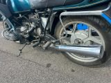 a motorcycle that is parked on the side of the street