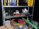 a metal shelf with many files and boxes on it