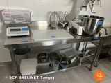 a kitchen counter with a mixer, mixer, and other items on it