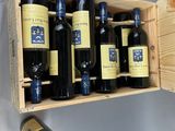 bottles of wine in a wooden box on a wall