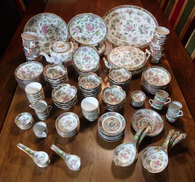 many plates and bowls on the table with spoons and spoons