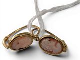 pair of pink stone earrings on a white string with a white cord