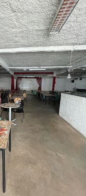a room with tables and chairs in it that is empty