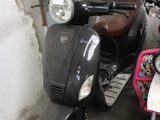 two scooters parked next to each other on the side of the street