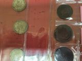 a lot of coins that are in a plastic case