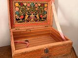 a small wooden box with a floral design on it