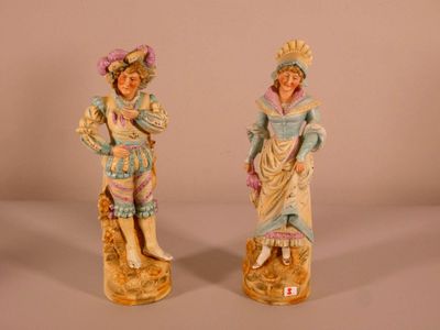 pair of antique figurines of a woman and a man