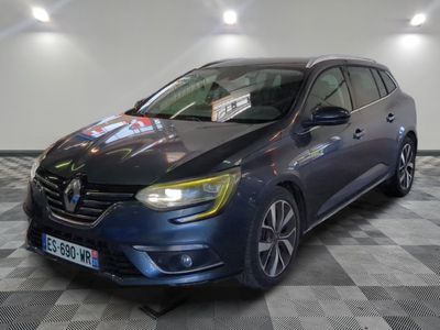 the blue car is parked on a checkered floor in a showroom
