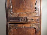 an old wooden cabinet with a mirror on top of it