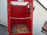 a red phone booth with a sign on the side of it
