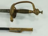a sword and a pen sitting on a table