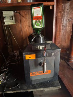 a machine that has a green bottle on top of it