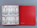 six verres dans une boîte rouge posée sur la table