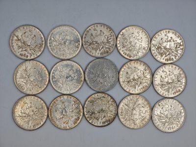 a group of silver coins sitting on top of a white surface