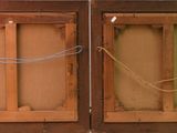 two wooden doors that are open on the side of a building