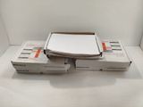 three boxes of nintendo wii controllers sitting on top of a white surface