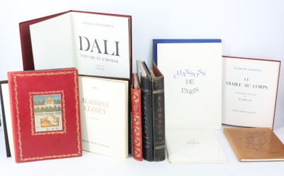 several books sitting on top of each other on top of a table