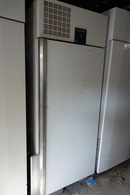 two refrigerators that are sitting in a room