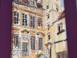 purple picture frame with a painting of a building on it