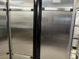 several stainless steel refrigerators are lined up in a kitchen