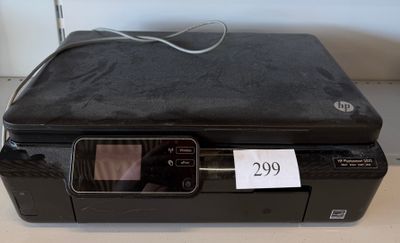 a black printer sitting on top of a table with a price tag on it