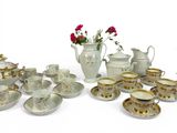 a lot of cups and saucers that are sitting on the table