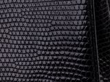 a close up of a black purse on a white background