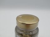 a jar of nuts sitting on a white surface