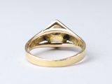 a close up of a gold ring with a diamond in the middle