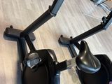 a row of stationary exercise bikes in a gym