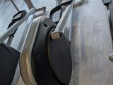 a row of stationary exercise bikes in a gym