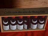 bottles of red wine in a wooden box on a red cloth