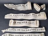four pieces of old newspaper on a table with a broken piece of paper